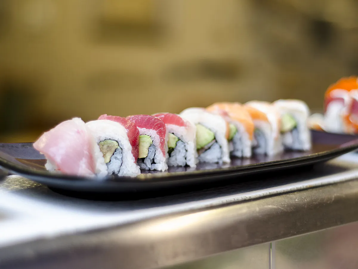 Fresh tuna salmon avocado sushi rolls on dark plate at Sushi One，a Japanese Restaurant in Portland
