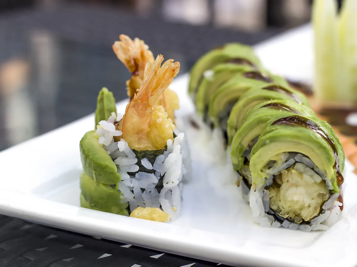 Tempura shrimp avocado sushi rolls on white plate at Sushi One，a Japanese Restaurant in Portland